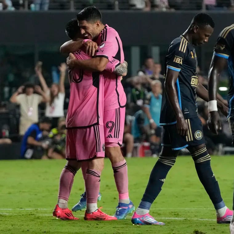 Inter Miami superstars Lionel Messi (left) and Luis Suárez embrace after Messi assisted on Suárez's late goal in Miami's 3-1 win over the Union on Saturday.