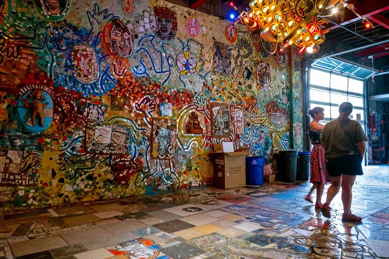 Philadelphia’s Magic Gardens Executive Director Emily Smith and Preservation & Facilities Manager Stacey Holder (right) on the first floor of the former studio of mosaic artist Isaiah Zagar, now owned by PMG.