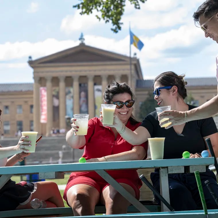 From left: Farah Vogel, Abbie Phillips, Sandy Sanchez-Bui, and Roland Bui enjoy drinks on Thursday, July 11, 2024, on opening day of the Oval Beer Garden in front of the Philadelphia Museum of Art.