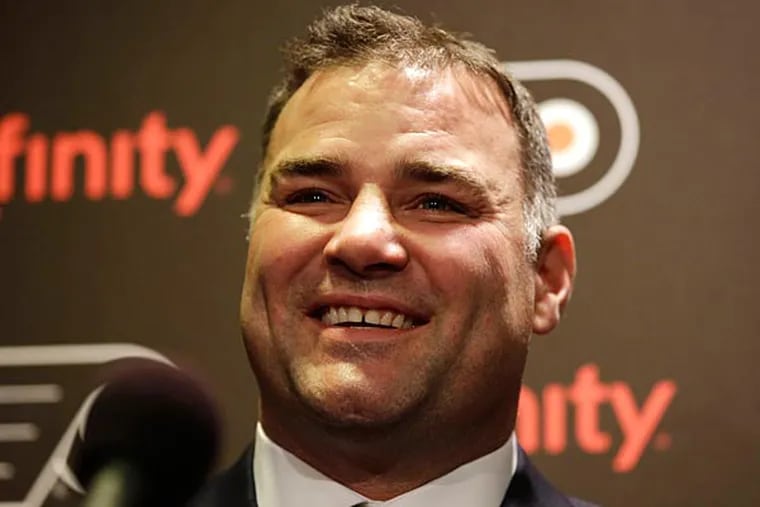 Former Philadelphia Flyers' Eric Lindros laughs while answering a question during a news conference before an NHL hockey game against
the Minnesota Wild, Thursday, Nov. 20, 2014, in Philadelphia. Lindros
and teammate John Leclair are being inducted into the Flyers Hall of
Fame in a ceremony before the game. (Matt Slocum/AP)