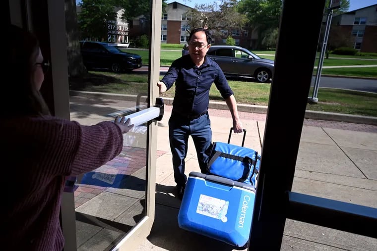 U.S. Rep. Andy Kim takes coolers with meals to the car as he rides along with Meals on Wheels volunteers in Lawrence Township on May 21.