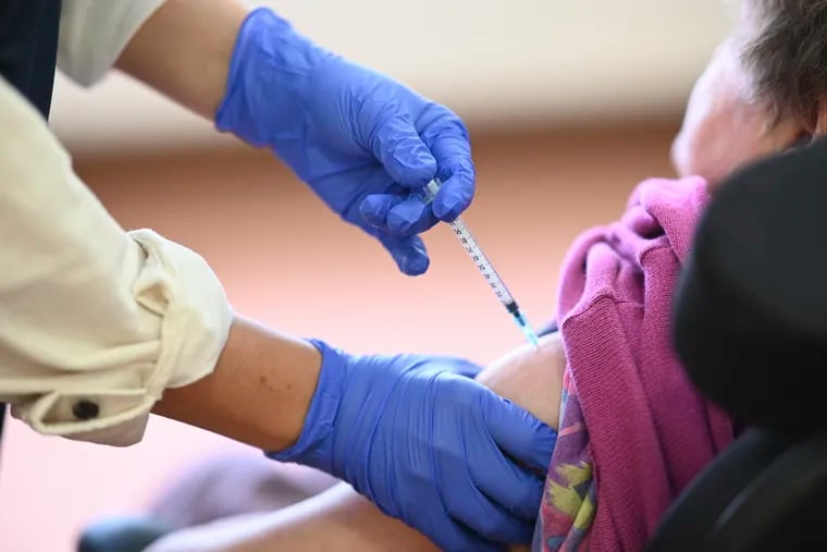 Medical student Mara Karcher vaccinates a resident of  Sankt Verena nursing home in Straßberg, Germany, Wednesday, Dec. 30, 2020.