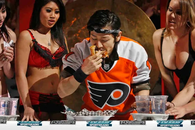 Takeru Kobayashi shows off for the chicks with a cheesesteak.