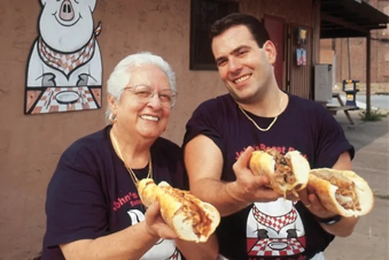 Vonda Bucci and her son, John Bucci Jr., serve up succulent steaks at John’s Roast Pork in South Philly in 2002.