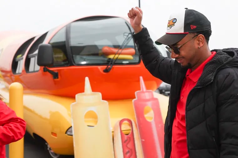 Garrison Kearse, known as “Glizzy G,” dances in front of the Oscar Mayer Wienermobile parked outside of the Walmart in South Philadelphia on Saturday.