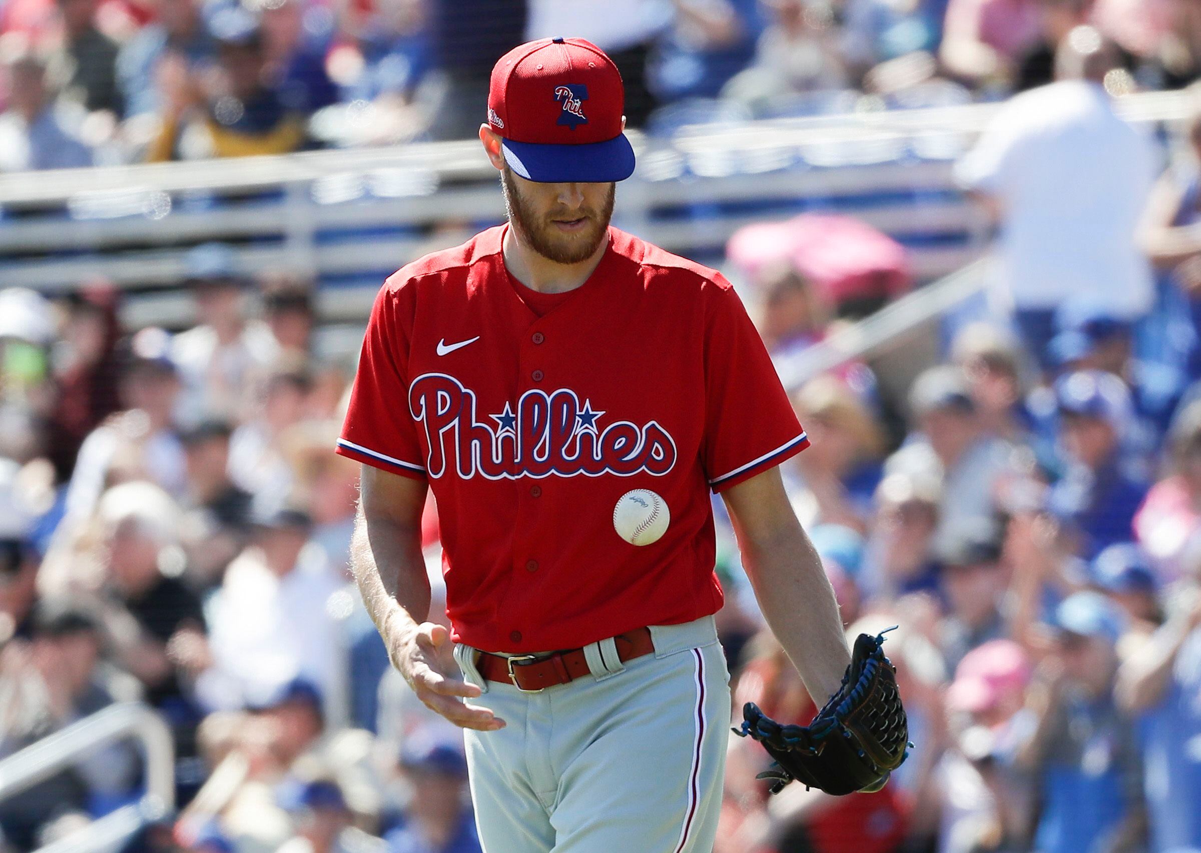 Philadelphia Phillies - Zack Wheeler, wearing the red pinstripe uniform,  about to throw a pitch.