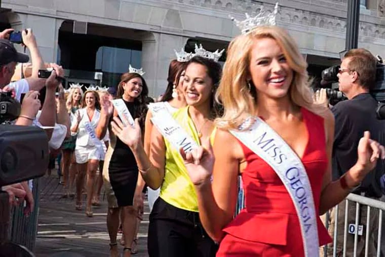 The 2015 Miss America competition kicks off with the arrival of contestants at Atlantic City's Kennedy Plaza on the boardwalk. Here, Miss Georgia, Maggie Bridges waves.( ED HILLE / Staff Photographer )
