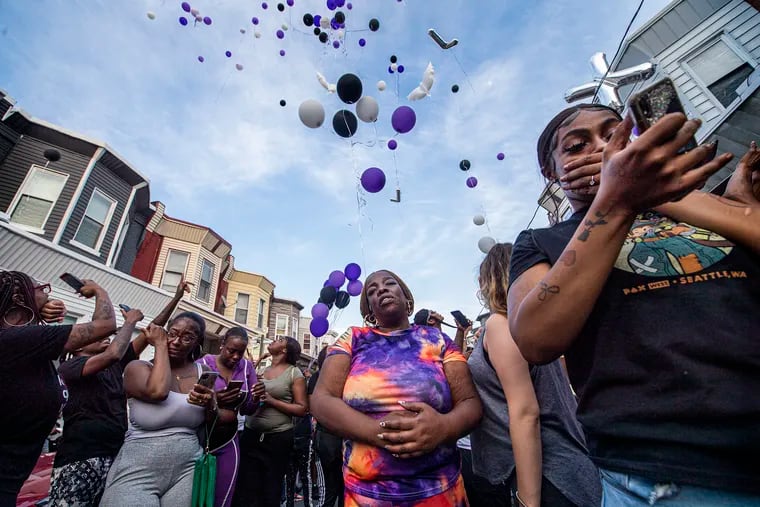 Lorraine Quinn, center, mother of Alexis Quinn, who was killed in the South Street shooting, gathers with friends and family during a vigil and balloon release in Philadelphia, Pa. Wednesday, June 8, 2022.