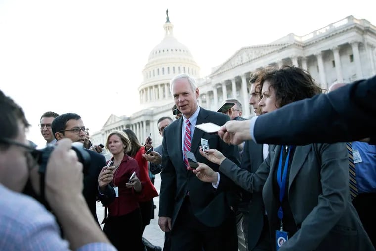 Sen. Ron Johnson (R., Wis), is surrounded by media as he walks from the Capitol building on Capitol Hill in Washington  on Wednesday.