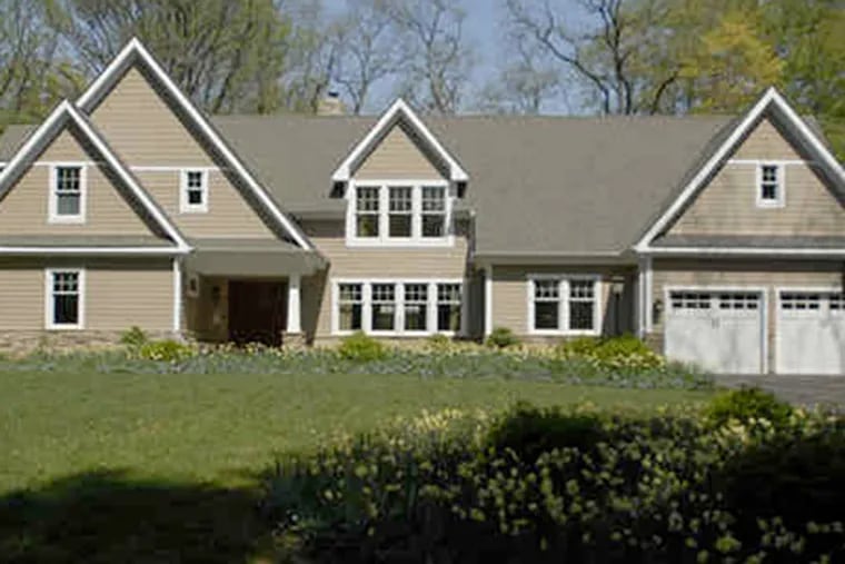 Tommy and Carol Romano's newly rebuilt two-story house integrated elements of a New England-style home and a Craftsman cottage. (Ron Tarver / Staff photographer)