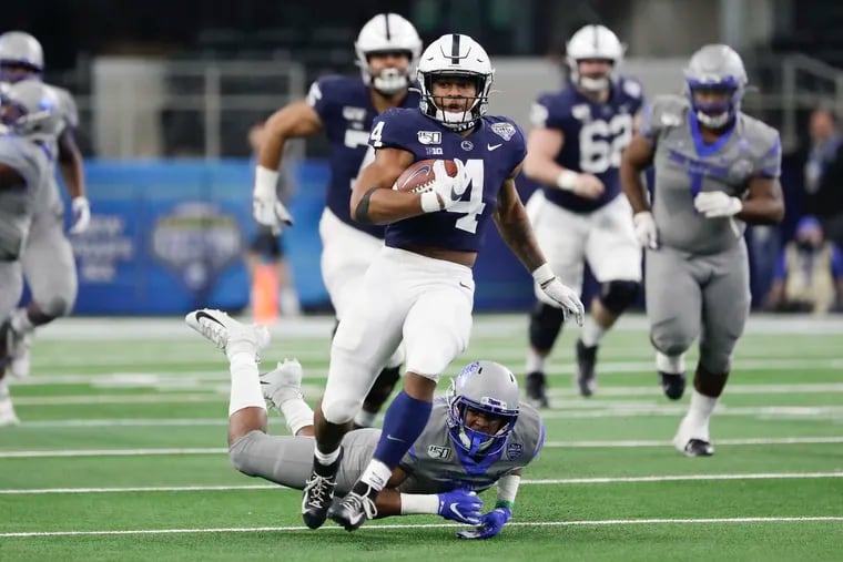 Penn State running back Journey Brown runs with the football past Memphis defensive back Quindell Johnson in the Cotton Bowl.