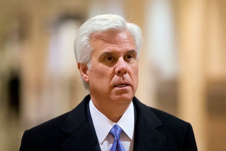 In this Nov. 13, 2013 file photo, New Jersey businessman George Norcross walks through City Hall in Philadelphia.