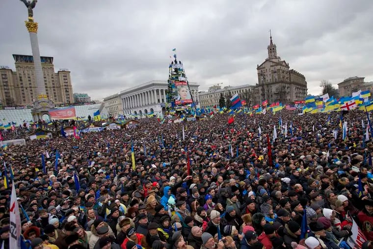 Hundreds of thousands attend a rally in the main square in Kiev. Opposition leaders urged demonstrators to surround all government buildings, while the government ordered them to leave.