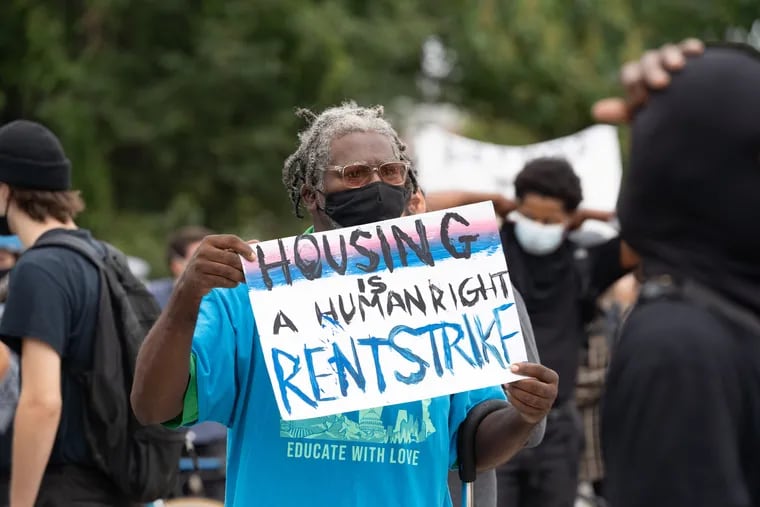 A person holds a sign at the encampment located at 21st and Ridge Avenue, where there is an eviction pending of people from the encampment by the city, in Philadelphia, September 09, 2020.