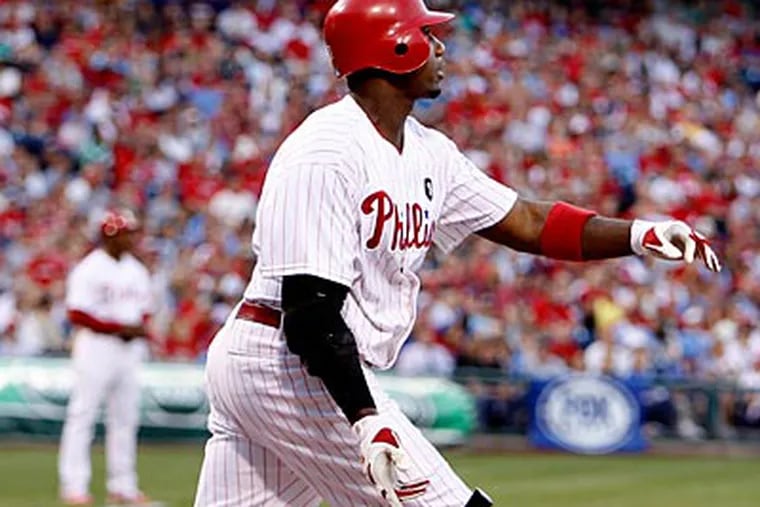 Ryan Howard watches the flight of his second inning home run against the Rangers' Colby Lewis. (Ron Cortes/Staff Photographer)