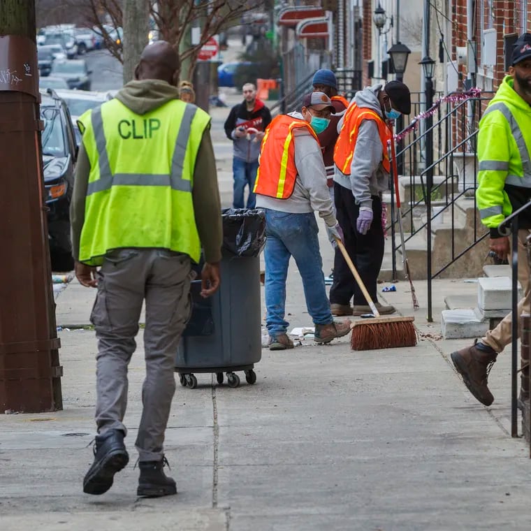 City workers with the Community Life Improvement Program (CLIP) cleaning along Huntingdon Street near Kensington Avenue in Philadelphia, Friday, March 15, 2024.