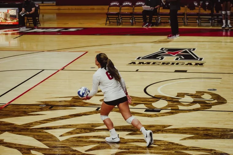 Temple sophomore libero Falanika Danielson prepares to serve during a volleyball match.