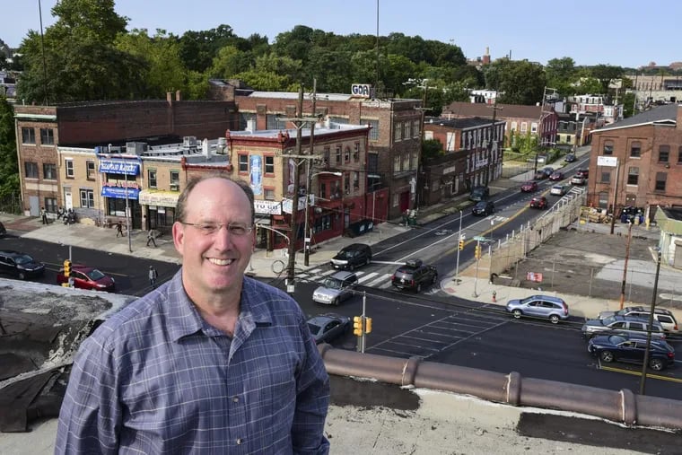 Mount Airy-based developer Ken Weinstein, 53, is on the roof of the Marv Levy building overlooking the intersection of Wayne Avenue and Berkley Street, an area he plans to redevelop.