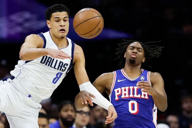 The Mavericks' Josh Green and the Sixers' Tyrese Maxey go for the ball on Monday at Well Fargo Center.