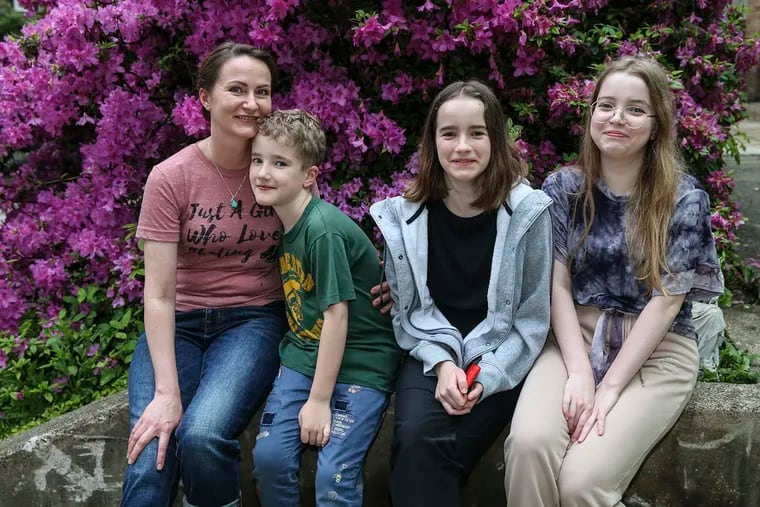 Veronika Pavliutina, a single mother, posing with her children on May 13. From left: Yegor, 8; Nina, 11, and Polina, 14.