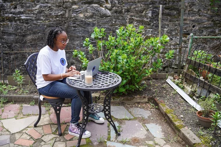 Camille Gaynus working in the backyard of her home in Philadelphia.