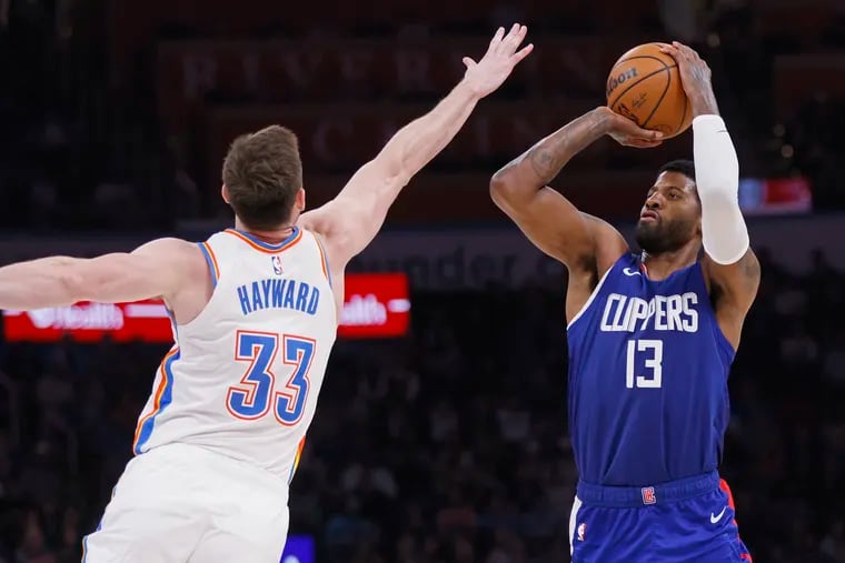 New Sixers forward Paul George (13) prepares to shoot over Gordon Hayward (33) during a game between the Los Angeles Clippers and Oklahoma City Thunder.
