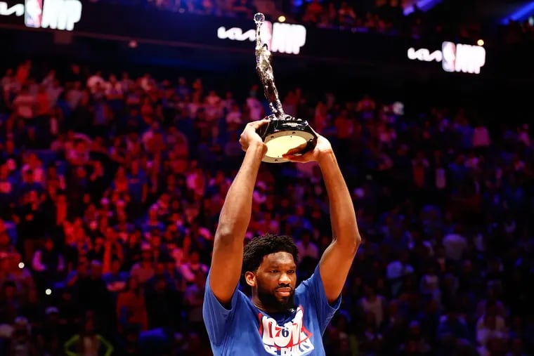 Sixers center Joel Embiid raises the MVP trophy during a ceremony before Game 3 of the Eastern Conference semifinals on May 5.