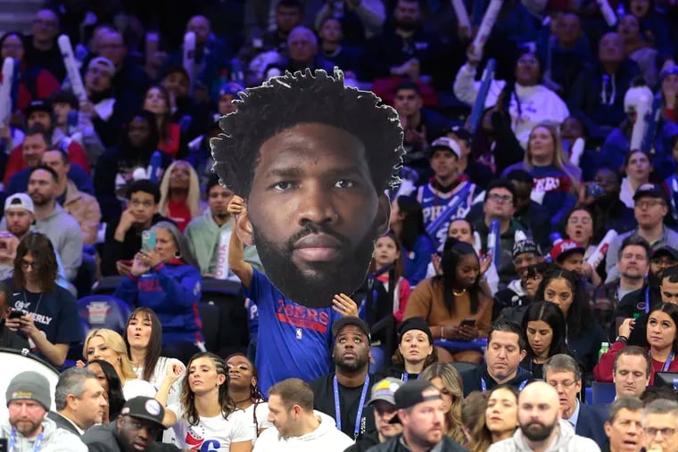 A big head of Joel Embiid of the Sixers held up in the crowd during the game against the Bulls at the Wells Fargo Center on Jan. 2, 2024.