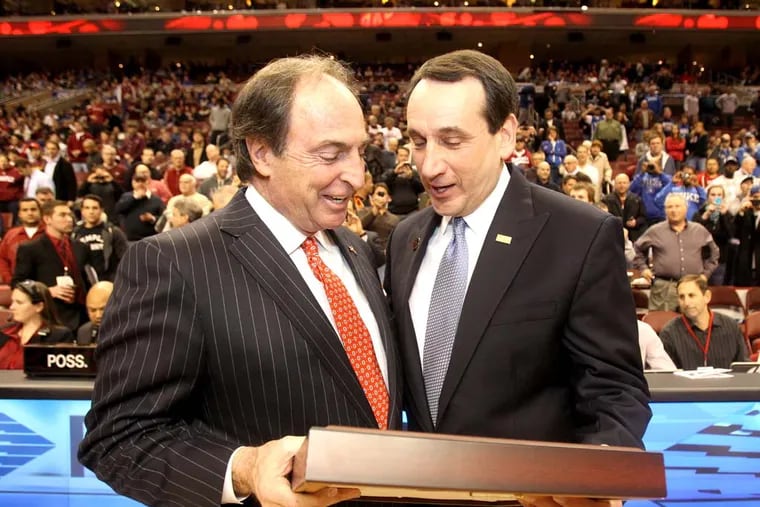 Temple Head Coach Fran Dunphy, left, presents Duke's Head Coach Mike Krzyzewski  with an award recognizing his achievements prior to the start of the game. Duke visits Temple University at a game played at the Wells Fargo Center.  ( Charles Fox / Staff Photographer )  OWLS05P, 01/04/2012, DUKE AT TEMPLE, WELLS FARGO CENTER, PHILA., PA