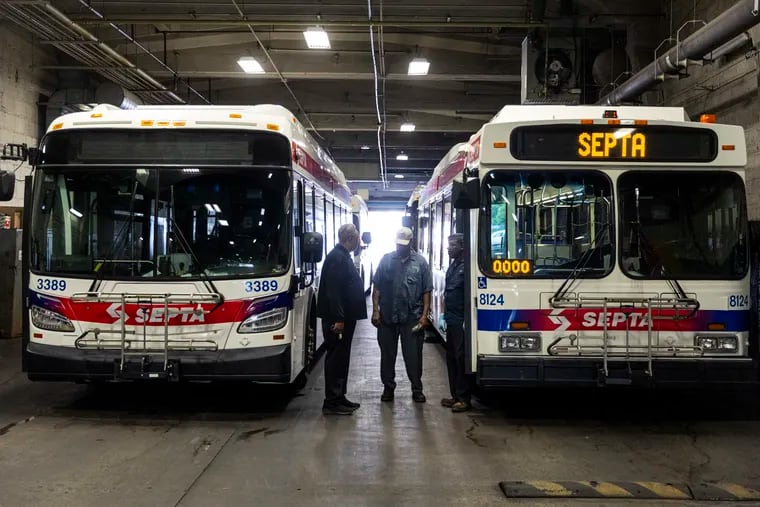 Brian Pollitt, President of TWU Local 234, (left), talks with Frank Hendrick, a SEPTA mechanic, (center), and Eric Gary, a diesel technician, (right), at the transit agency's Callowhill Depot on Tuesday, July 25, 2023.