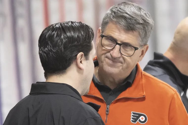 Keith Jones (right), the Flyers' president of hockey operations, speaking with general manager Daniel Brière during practice earlier this month.