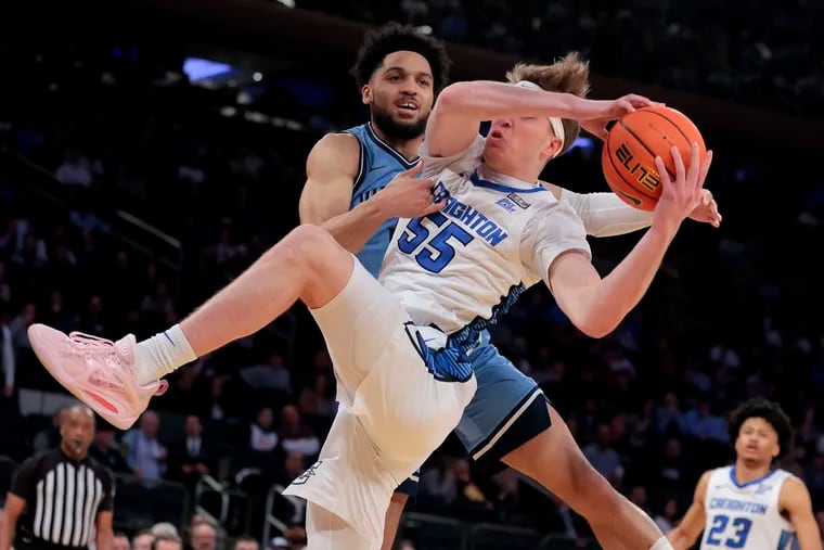 Villanova's Caleb Daniels (top) fouls Creighton's Baylor Scheierman as the two battle for a rebound Thursday night in the quarterfinals of the Big East tournament.