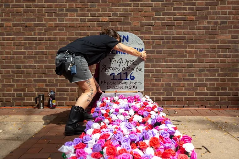 Catalyst Twomey sets up a memorial with a rose that signifies each of the 1,116 deaths to overdose in Philadelphia in 2018 at the Federal Courthouse in Philadelphia in 2019 during a protest advocating for the city to open a supervised injection site. Philadelphia officials say overdose deaths among all residents decreased in 2023, but deaths among Black and Hispanic residents are rising.