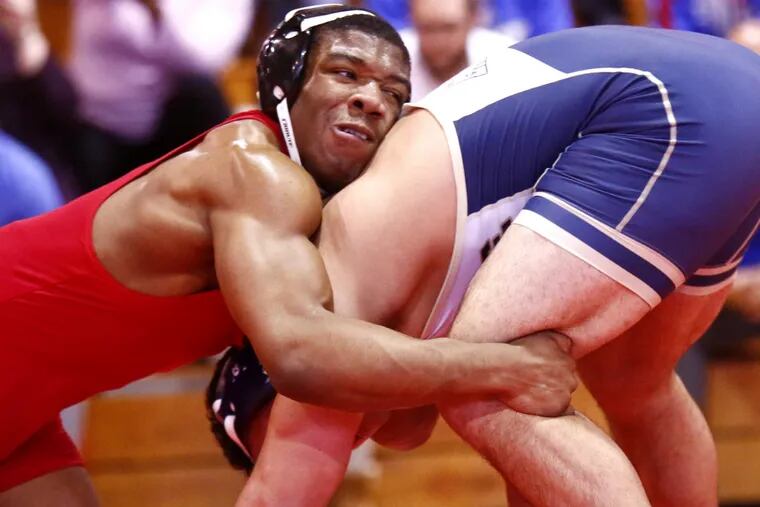 Miles Lee (left) of Southern has a hold of La Salle's Anthony Piscopo during their 195-pound final Saturday at the District 12 Class AAA wrestling championships at Archbishop Carroll.