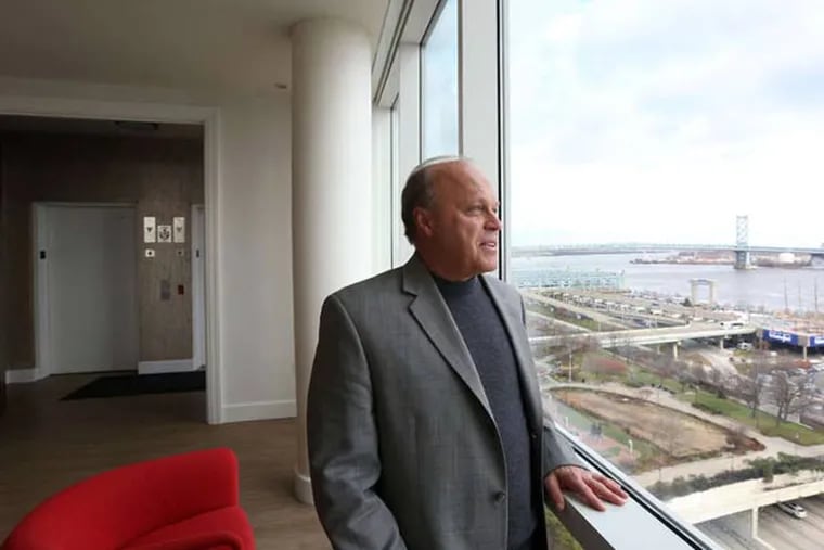 Contractor Alfred Hagen takes in the views from his 4,000-square-foot residence atop a 12-story boutique building in Society Hill. He recently relocated from Bucks.