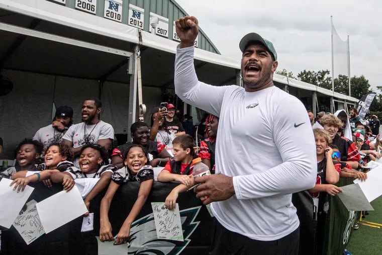 Eagles tackle Jordan Mailata joins the young fans chanting as they try to get Saquon Barkley to come over and sign autographs following a training camp practice on Thursday.