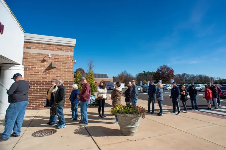 A line of people wait to cast their ballots Tuesday at Central Bucks East High School.