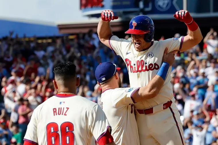 Phillies catcher J.T. Realmuto leaps into the arms of Kody Clemens after his game-winning RBI single in the ninth inning against the Mets.