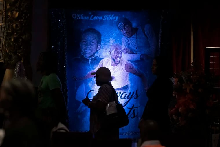 A mourner waits in line to pay respects to O’Shae Sibley The Met in Philadelphia on Tuesday.