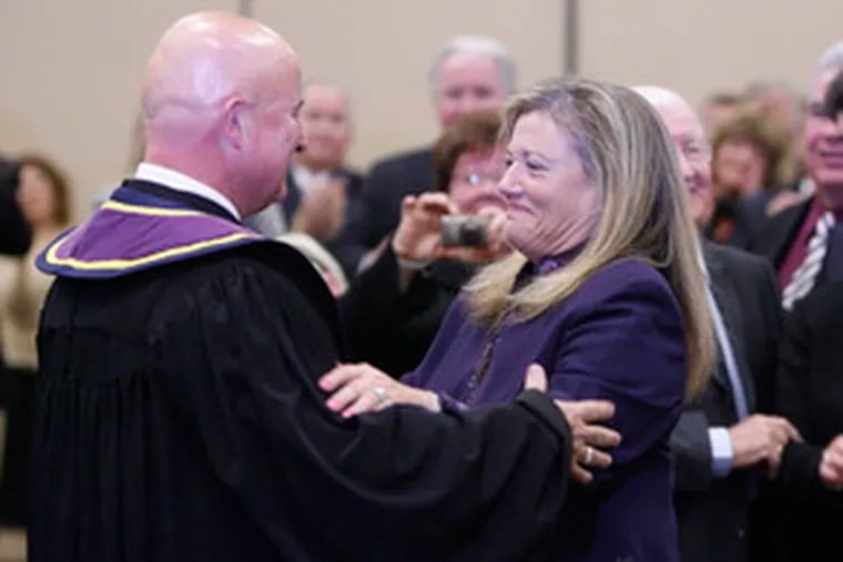 McCaffery is hugged by his wife, Lise Rapaport , after being sworn in as a justice of the Pennsylvania Supreme Court.