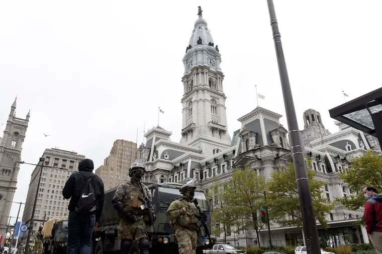 Members of the Pennsylvania National Guard patrol in front of City Hall, Friday, Oct. 30, 2020, in Philadelphia. (AP Photo/Michael Perez)