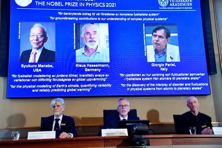 Secretary General of the Royal Swedish Academy of Sciences Goran Hansson, center, flanked by member of the Nobel Committee for Physics Thors Hans Hansson, left, and member of the Nobel Committee for Physics John Wettlaufer, announces the winners of the 2021 Nobel Prize in Physics at the Royal Swedish Academy of Sciences in Stockholm on Tuesday.