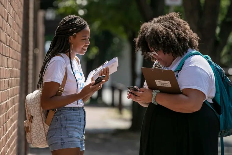 Alexis Perry (left), 21, and Danielle Foltz, 20, canvass for judges on the ballot in November, as part of the DNC’s Organizing Corps 2020 initiative, in Old City Philadelphia last month.