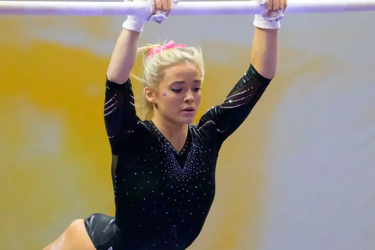 LSU gymnast Olivia "Livvy" Dunne performs on the uneven bars during an NCAA gymnastics meet in 2022. Dunne has earned almost $4 million through endorsement deals.