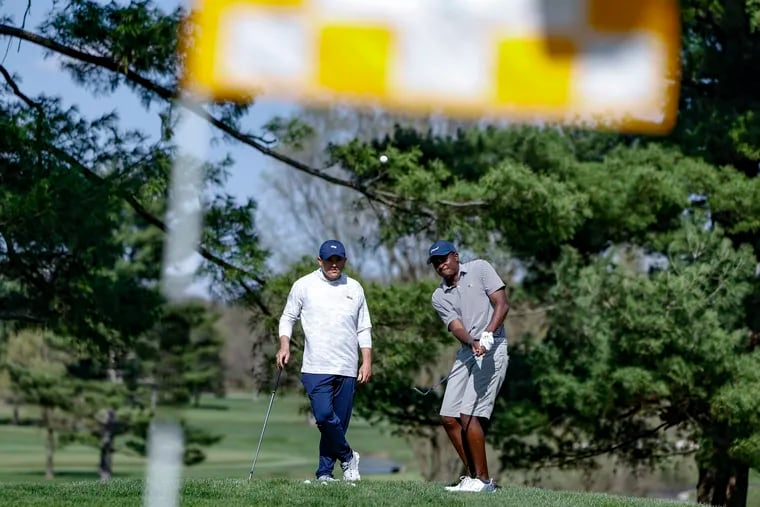 Drexel golf coach Ben Feld, left, works with senior Tafadzwa Nyamukondiwa at the Green Valley Country Club in Lafayette Hill earlier this year.