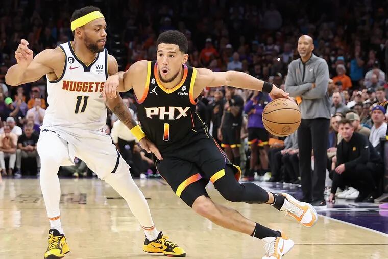 Devin Booker of the Phoenix Suns handles the ball against Bruce Brown of the Denver Nuggets during the second half of Game Four of the NBA Western Conference Semifinals at Footprint Center on May 07, 2023 in Phoenix, Arizona. The Suns defeated the Nuggets 129-124.