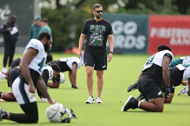 Eagles coach Nick Sirianni watches as the players warm up at the NovaCare Complex on Sunday.