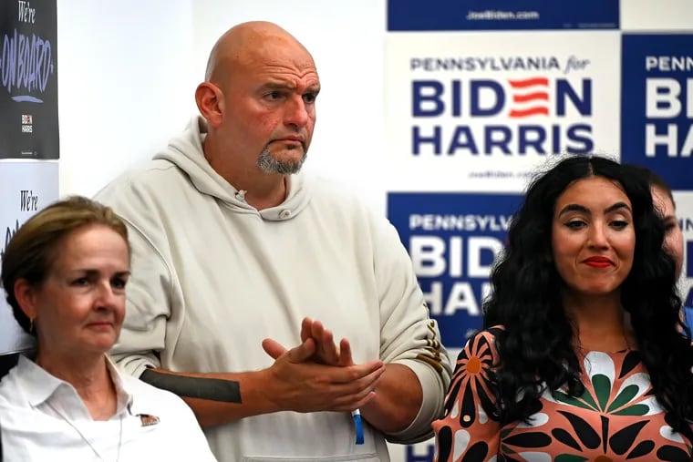 U.S. Sen. John Fetterman and his wife Gisele Barreto Fetterman (right) stand in the crowd as President Joe Biden greets volunteers at a campaign office in Roxborough on Sunday.