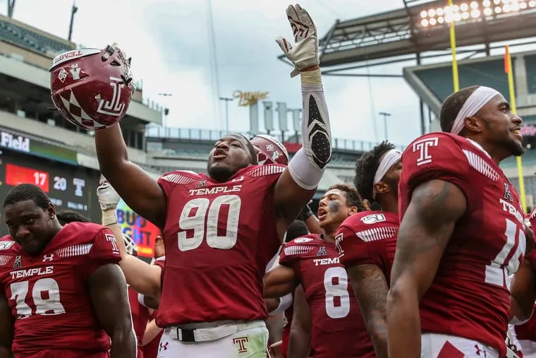 Temple defensive end Quincy Roche (90) raises his arms while his team celebrates with their fans after defeating Maryland in September.