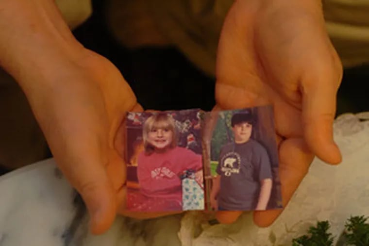 Charles Bennett displays photographs of two of his grandchildren - Melanie (left), 6, and Scottie, 12 - who were murdered by their father in May 2006.